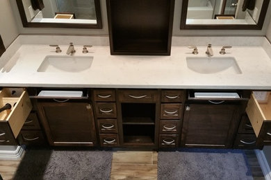 Large master porcelain tile porcelain tile walk-in shower photo in Houston with an undermount sink, shaker cabinets, dark wood cabinets, quartz countertops and gray walls