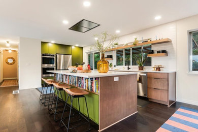 Kitchen - mid-sized 1960s dark wood floor and brown floor kitchen idea in Portland with an undermount sink, flat-panel cabinets, green cabinets, quartz countertops, white backsplash, ceramic backsplash, stainless steel appliances, an island and white countertops