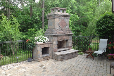 Design ideas for a mid-sized country backyard patio in Louisville with a fire feature, concrete pavers and no cover.