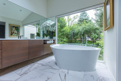 Mid-sized modern master bathroom in Cincinnati with flat-panel cabinets, medium wood cabinets, a freestanding tub, white walls, medium hardwood floors, quartzite benchtops, brown floor and white benchtops.