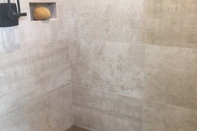Inspiration for a large rustic master beige tile and porcelain tile brown floor bathroom remodel in Other with a one-piece toilet and beige walls