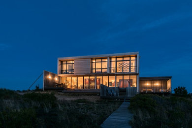 Large minimalist beige two-story wood exterior home photo in Boston