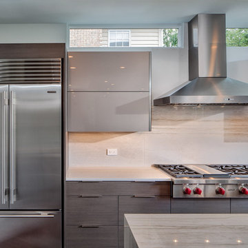 Gray cabinet kitchen with back-painted glass upper cabinets