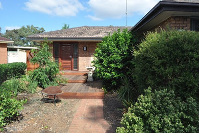 Photo of a small traditional one-storey brick beige exterior in Central Coast.