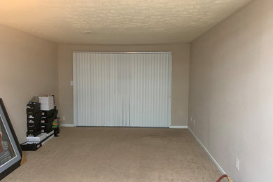 Tuscan formal and enclosed living room photo with a wall-mounted tv