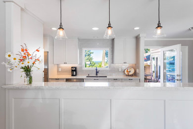 Mid-sized transitional galley porcelain tile and brown floor enclosed kitchen photo in Portland with an undermount sink, recessed-panel cabinets, white cabinets, granite countertops, a peninsula and gray countertops