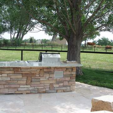 Great Flagstone Patio and Outdoor Kitchen with a Great Gas Fire Pit