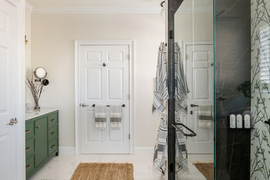 Example of a large transitional master single-sink walk-in shower design with shaker cabinets, green cabinets, an undermount sink, marble countertops, a hinged shower door, gray countertops and a freestanding vanity