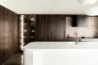 Large contemporary single-wall open plan kitchen in Other with dark wood cabinets, brown splashback and brown worktops.