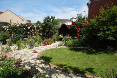 Design ideas for a medium sized traditional back partial sun garden for summer in London with gravel.