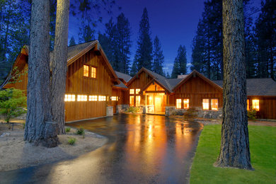 Inspiration for a large rustic beige one-story wood gable roof remodel in Other