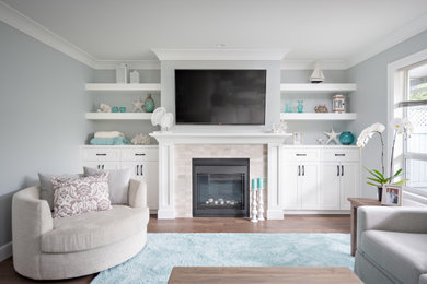 Family room - mid-sized rustic open concept medium tone wood floor and brown floor family room idea in Vancouver with blue walls, a standard fireplace, a tile fireplace and a wall-mounted tv