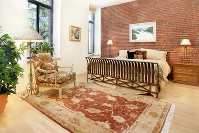 Example of a large urban master light wood floor bedroom design in Boston with white walls