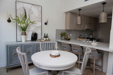 Mid-sized beach style light wood floor and beige floor kitchen/dining room combo photo in Orange County with white walls