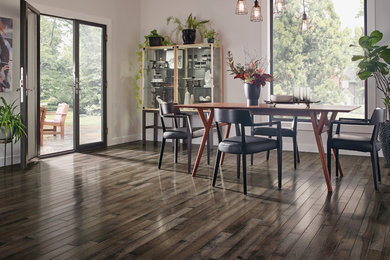 Mid-sized trendy dark wood floor and brown floor great room photo in Los Angeles with white walls and no fireplace