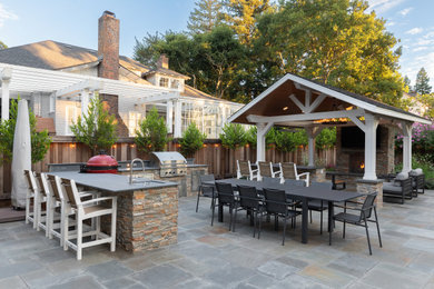 Photo of a mid-sized traditional backyard stone landscaping in San Francisco with a pergola.