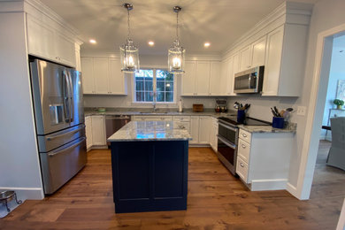 Small trendy u-shaped enclosed kitchen photo in Boston with an island