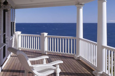 Inspiration for a large victorian balcony remodel in Boston with a roof extension