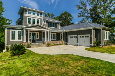 Large transitional brown two-story wood house exterior photo in Other with a hip roof and a shingle roof
