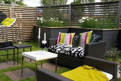 This is an example of a small contemporary backyard patio in Melbourne with natural stone pavers.