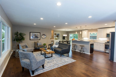 Kitchen - transitional kitchen idea in Milwaukee with white cabinets, stainless steel appliances and an island
