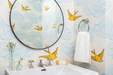Small eclectic wallpaper powder room photo in Philadelphia with multicolored walls and a wall-mount sink