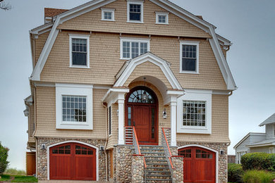 Large victorian beige three-story wood exterior home idea in New York with a gambrel roof