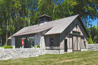 Large transitional multicolored one-story mixed siding gable roof photo in New York with a mixed material roof and a brown roof