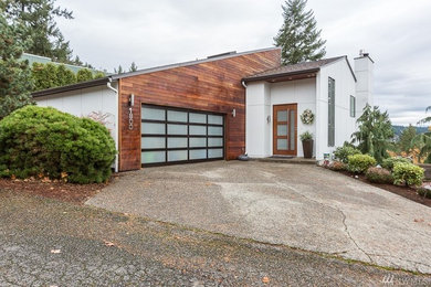Inspiration for a modern white split-level concrete fiberboard house exterior remodel in Seattle