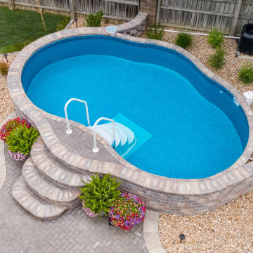 Freeform Semi-inground Stealth with stone steps and landscaping