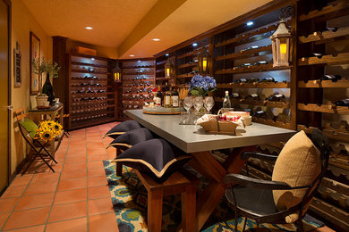 Small country wine cellar in San Francisco with terra-cotta floors and storage racks.