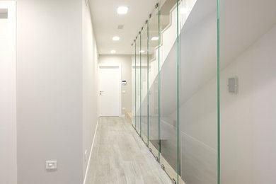 Mid-sized contemporary hallway in Milan with grey walls and porcelain floors.