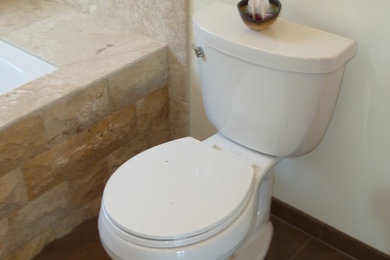Example of a large trendy master beige tile and stone tile travertine floor bathroom design in San Francisco with a two-piece toilet and beige walls
