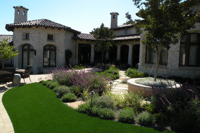 Inspiration for a mediterranean backyard full sun garden in San Francisco with natural stone pavers.