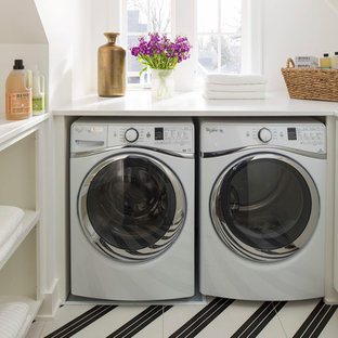Photo of a contemporary u-shaped utility room in Minneapolis with open cabinets, white cabinets, white walls, a side by side washer and dryer, multi-coloured floors and white worktops.