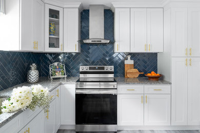 Eat-in kitchen - mid-sized transitional l-shaped vinyl floor and gray floor eat-in kitchen idea in Charlotte with an undermount sink, shaker cabinets, granite countertops, blue backsplash, ceramic backsplash, stainless steel appliances and an island