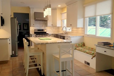 Mid-sized transitional u-shaped porcelain tile and beige floor eat-in kitchen photo in Calgary with a farmhouse sink, beaded inset cabinets, white cabinets, granite countertops, white backsplash, ceramic backsplash, stainless steel appliances and an island