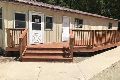 Large side yard deck photo in Other