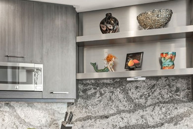 Kitchen - large modern u-shaped porcelain tile and gray floor kitchen idea in Los Angeles with a farmhouse sink, flat-panel cabinets, medium tone wood cabinets, quartzite countertops, gray backsplash, stainless steel appliances and gray countertops