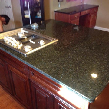 Traditional Dark ubatuba coutertops with cherry cabinets