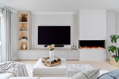 Example of a family room design in Toronto with a wall-mounted tv