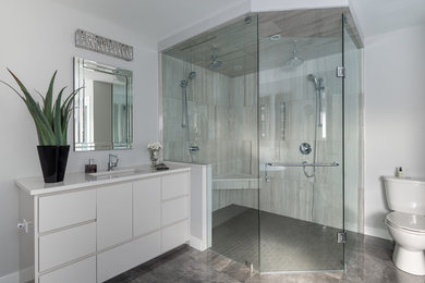 Bathroom - large contemporary master brown tile and porcelain tile porcelain tile bathroom idea in Toronto with flat-panel cabinets, white cabinets, a one-piece toilet, gray walls, an undermount sink and quartz countertops
