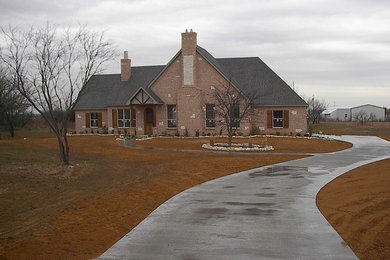 Inspiration for a large timeless brown two-story exterior home remodel in Dallas with a shingle roof