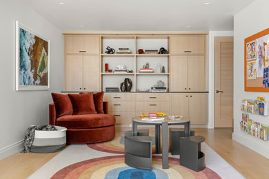 Photo of a medium sized classic playroom in New York with beige walls, light hardwood flooring and beige floors.