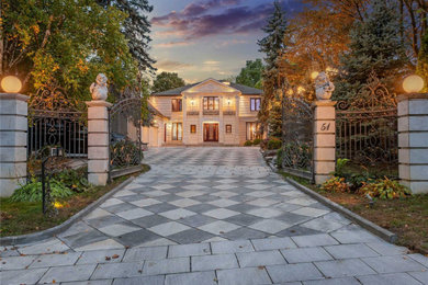 Transitional beige two-story stone house exterior idea in Toronto