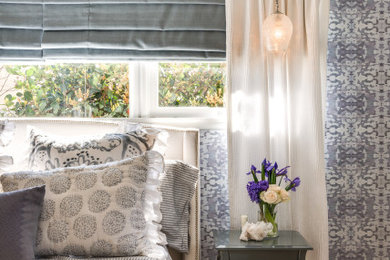 Inspiration for a mid-sized transitional master medium tone wood floor bedroom remodel in Los Angeles with blue walls