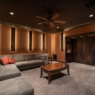 Inspiration for a large rustic open plan home cinema in Houston with orange walls, carpet and a wall mounted tv.