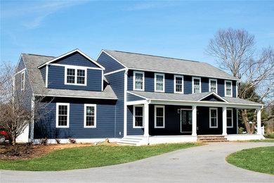 This is an example of a large traditional two-storey blue house exterior in DC Metro with concrete fiberboard siding.
