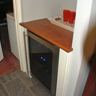 Example of a mid-sized classic enclosed slate floor home theater design in Portland Maine with a wall-mounted tv