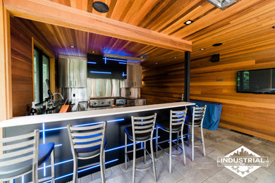 Photo of a modern kitchen in Portland with a submerged sink, stainless steel cabinets, granite worktops, stainless steel appliances and concrete flooring.